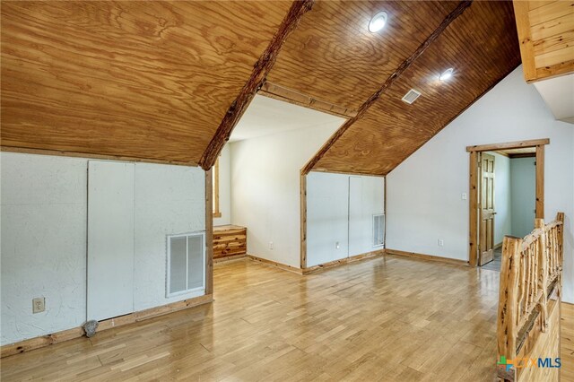 additional living space with wood ceiling, vaulted ceiling, and light wood-type flooring