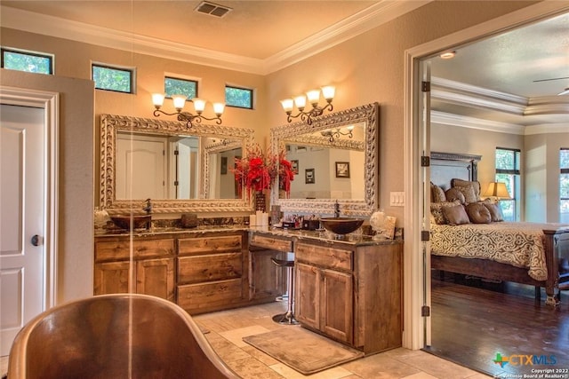 bathroom with visible vents, a soaking tub, crown molding, connected bathroom, and vanity