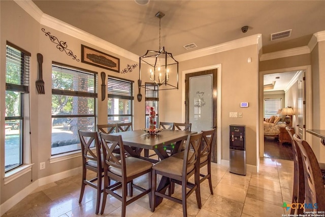 dining space featuring baseboards, visible vents, crown molding, and an inviting chandelier