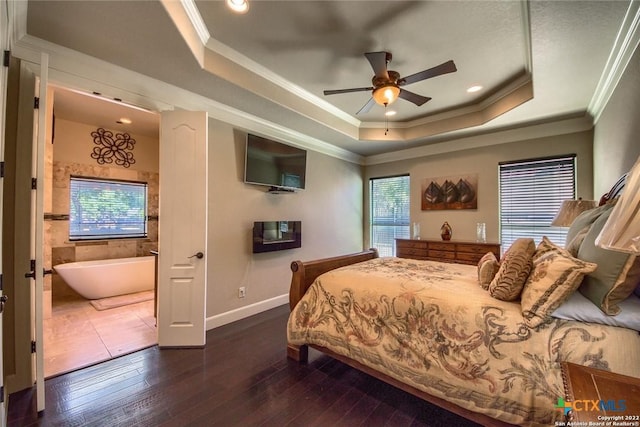 bedroom with dark wood-style flooring, crown molding, and a raised ceiling