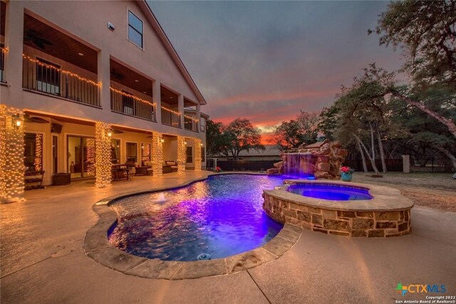 view of pool with a pool with connected hot tub and a patio area