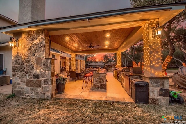 view of patio with area for grilling and ceiling fan