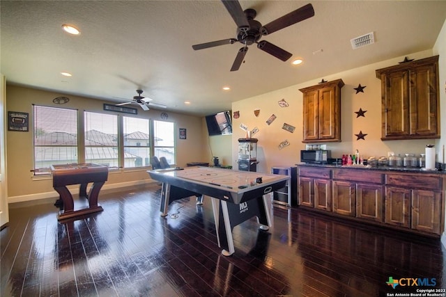 game room featuring a ceiling fan, baseboards, visible vents, recessed lighting, and dark wood-style flooring