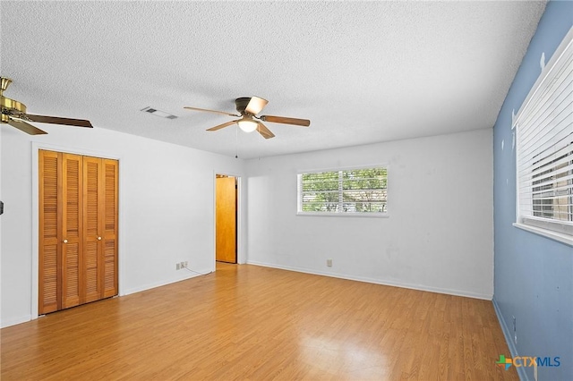 408 Royal Oak Dr, Victoria, TX 77905 - unfurnished room featuring a ceiling fan, wood finished floors, a textured ceiling, and baseboards