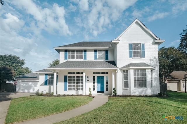 front facade featuring a garage and a front yard