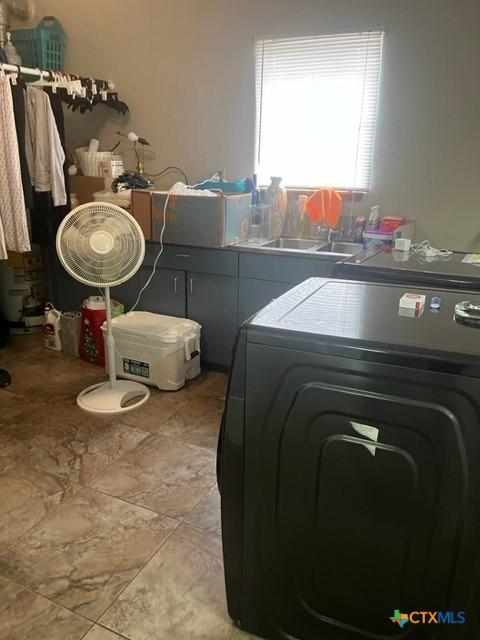 laundry area with washer / clothes dryer, laundry area, and a sink