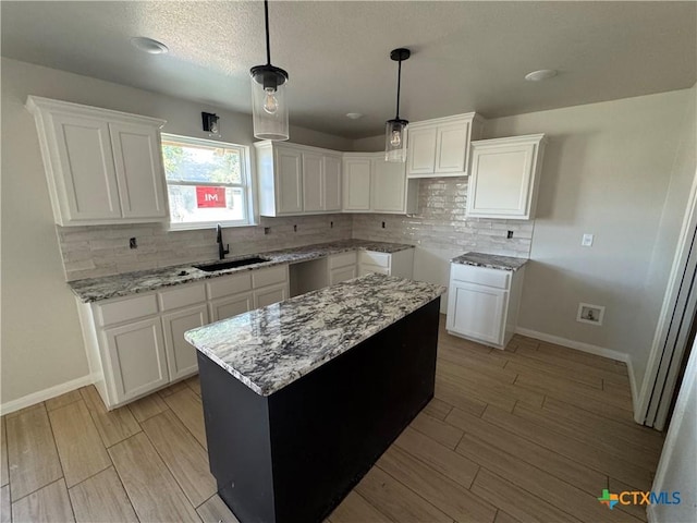 2516 Cowgirl Trl, Belton, TX 76513 - kitchen with tasteful backsplash, light wood-style flooring, light stone countertops, and a textured ceiling