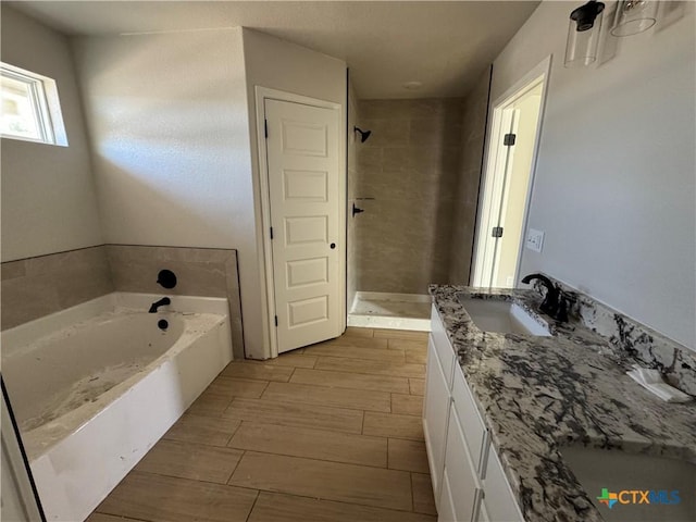 2516 Cowgirl Trl, Belton, TX 76513 - bathroom with a stall shower, vanity, wood finish floors, and a garden tub