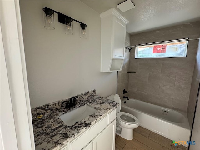 2516 Cowgirl Trl, Belton, TX 76513 - bathroom with tub / shower combination, vanity, wood finished floors, and a textured ceiling