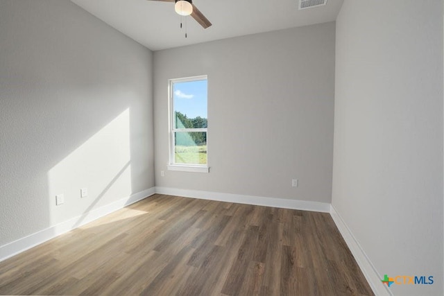 empty room featuring dark hardwood / wood-style floors and ceiling fan