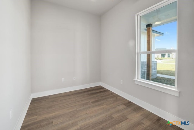 spare room with dark wood-type flooring