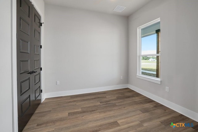 unfurnished room featuring dark hardwood / wood-style floors