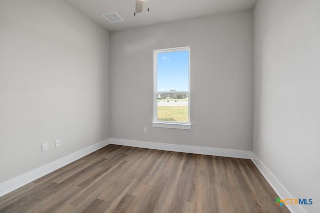 spare room with wood-type flooring