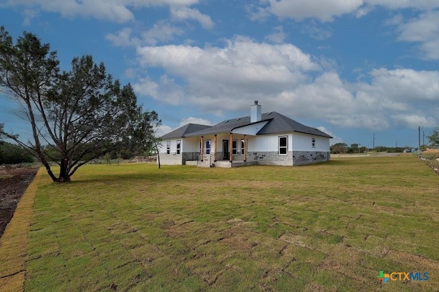 back of house with a yard