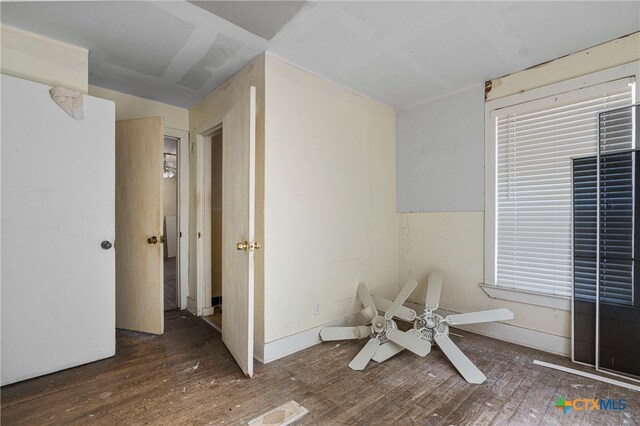 interior space featuring ceiling fan and dark hardwood / wood-style floors