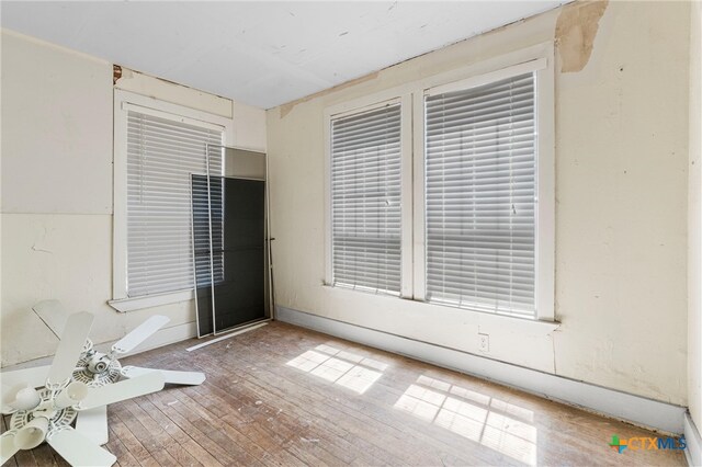 empty room featuring hardwood / wood-style flooring and ceiling fan