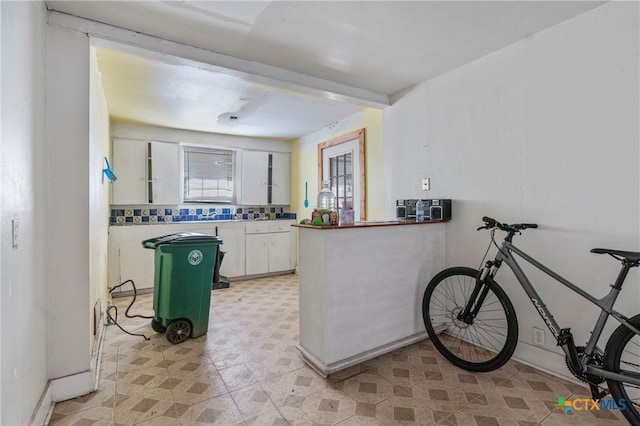 kitchen with white cabinets and kitchen peninsula