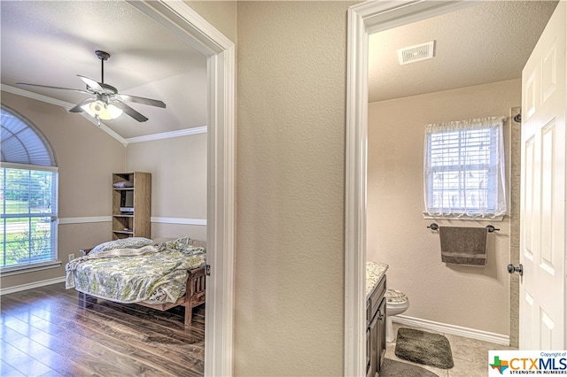 bedroom with ornamental molding, dark hardwood / wood-style flooring, and ceiling fan