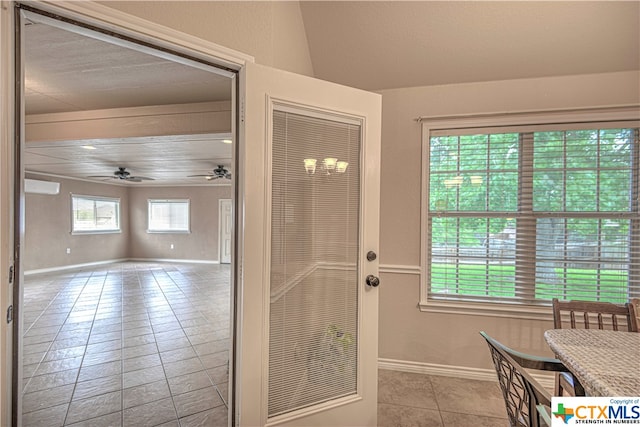 entryway featuring ceiling fan, a wealth of natural light, and light tile patterned flooring