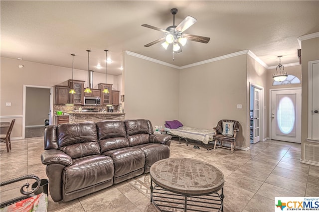 living room with ceiling fan, crown molding, and light tile patterned floors