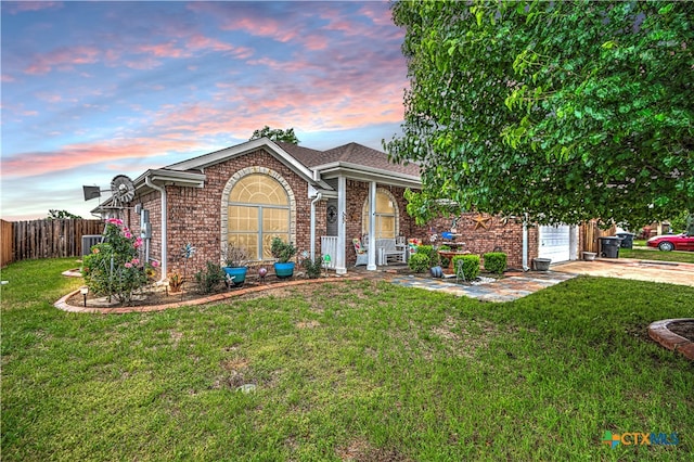 view of front of property featuring a garage and a yard