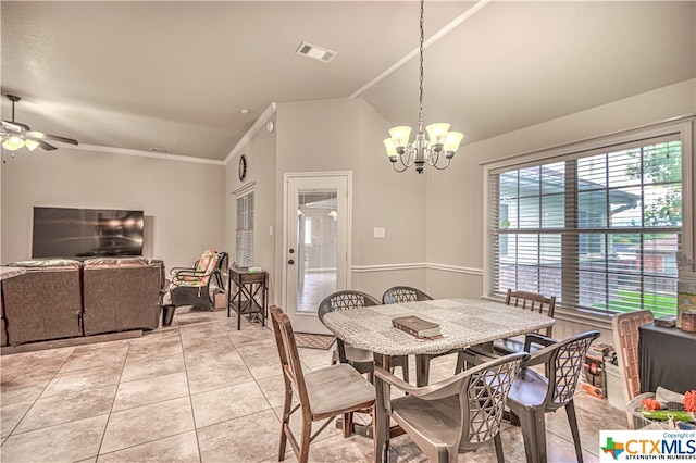 tiled dining area featuring lofted ceiling, ornamental molding, and ceiling fan with notable chandelier