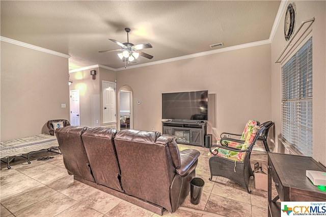 living room with ornamental molding and ceiling fan