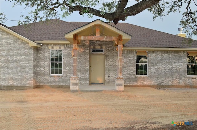 425 County Road 3152, Kempner, TX 76539 - view of front of house with roof with shingles, brick siding, and a chimney