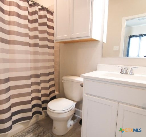 bathroom with walk in shower, vanity, and toilet