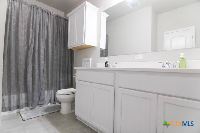 bathroom with tile patterned flooring, vanity, and toilet