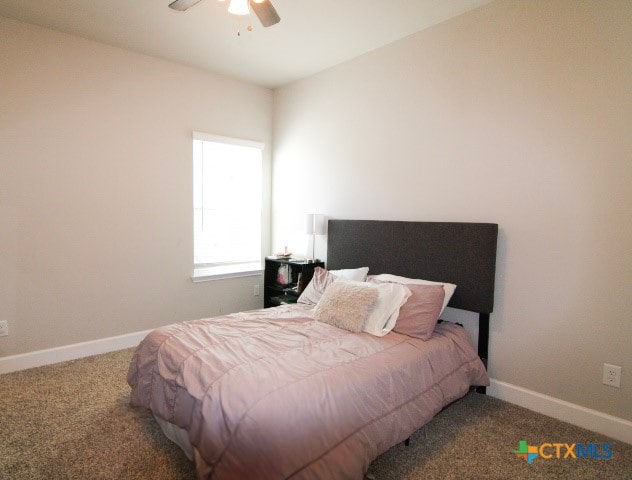 carpeted bedroom featuring ceiling fan