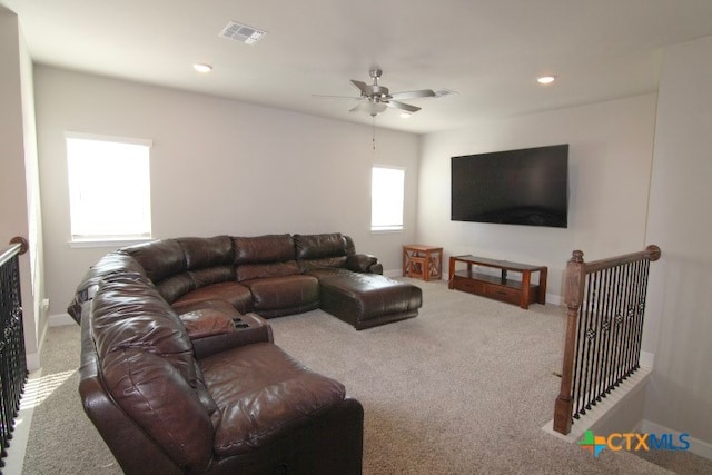 living room with ceiling fan, light colored carpet, and a healthy amount of sunlight