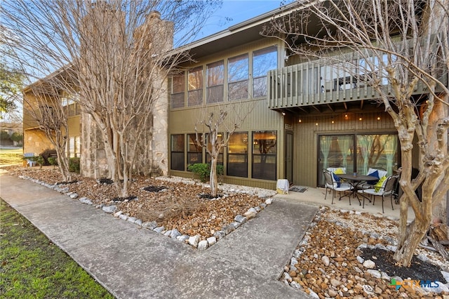 exterior space featuring a balcony and a patio area