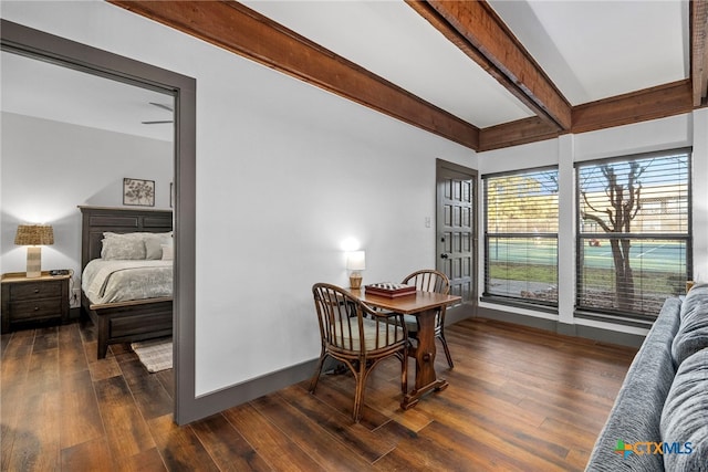 dining space with dark wood-style flooring, baseboards, and beam ceiling