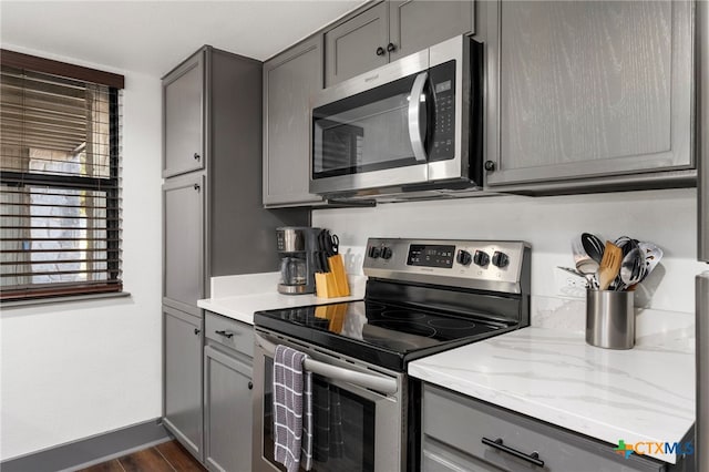 kitchen featuring stainless steel appliances and gray cabinets