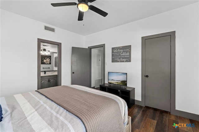 bedroom featuring ceiling fan, visible vents, dark wood-style flooring, and ensuite bathroom