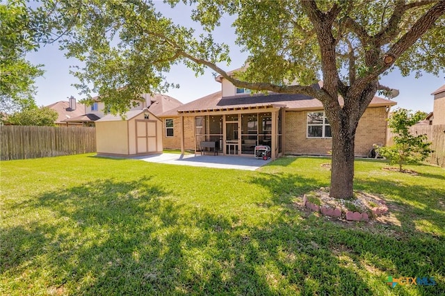 106 Sandstone Ct, Victoria, TX 77904 - rear view of property featuring a sunroom, brick siding, and a patio area