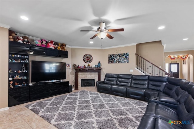 106 Sandstone Ct, Victoria, TX 77904 - living area featuring crown molding, ceiling fan, recessed lighting, stairs, and a tiled fireplace