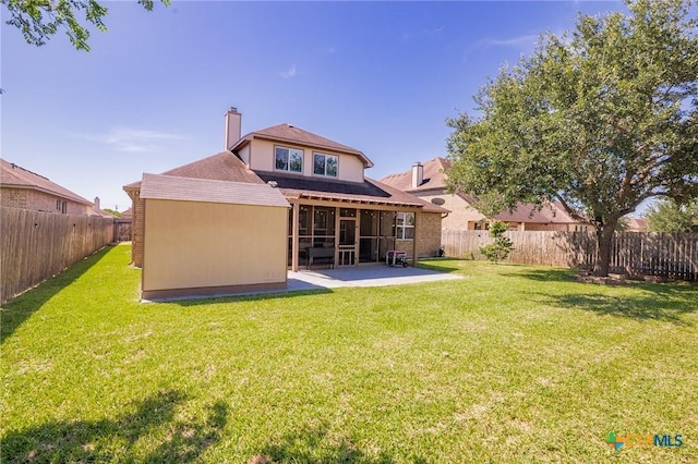 106 Sandstone Ct, Victoria, TX 77904 - rear view of house featuring a sunroom, a chimney, a patio area, and roof with shingles