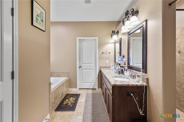 106 Sandstone Ct, Victoria, TX 77904 - bathroom featuring a garden tub, double vanity, and tile patterned floors