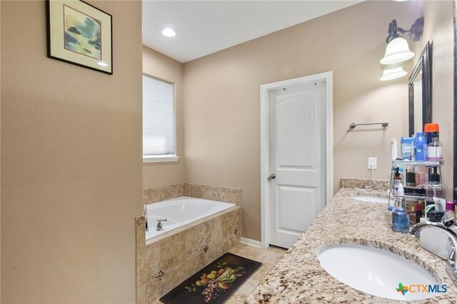 106 Sandstone Ct, Victoria, TX 77904 - bathroom with a garden tub, double vanity, and tile patterned flooring