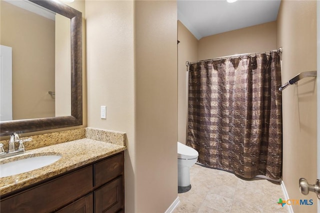 106 Sandstone Ct, Victoria, TX 77904 - bathroom featuring toilet, vanity, a shower with curtain, and baseboards