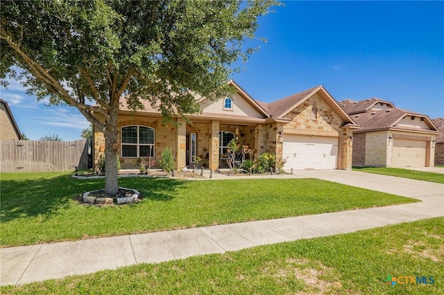 106 Sandstone Ct, Victoria, TX 77904 - single story home with an attached garage, driveway, stone siding, and covered porch