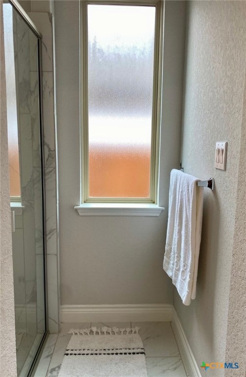 429 Juana Way, New Braunfels, TX 78132 - bathroom featuring a marble finish shower, marble look tiles, and baseboards