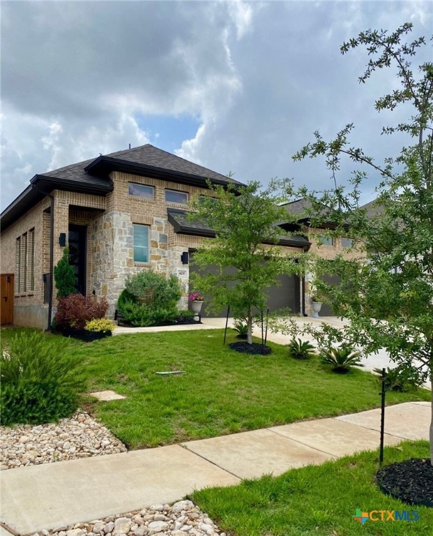 429 Juana Way, New Braunfels, TX 78132 - prairie-style house with a front yard, brick siding, and an attached garage