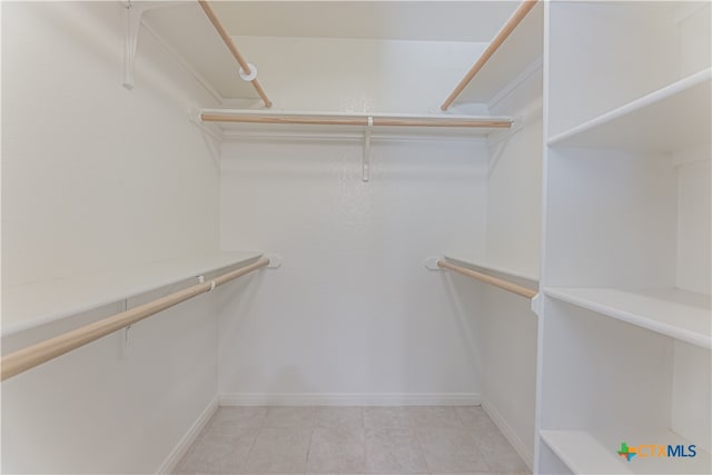 spacious closet with light tile patterned floors