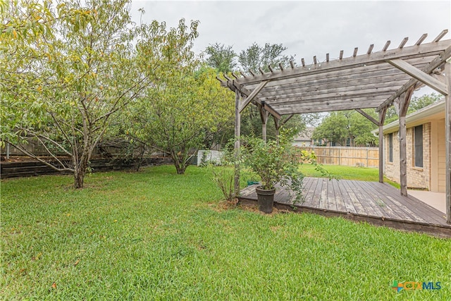 view of yard featuring a wooden deck and a pergola