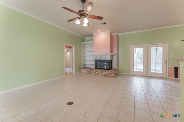 unfurnished living room with a fireplace, ceiling fan, light tile patterned floors, and crown molding