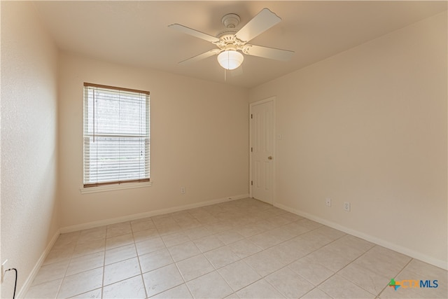 tiled empty room with ceiling fan