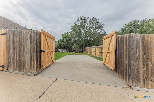 view of gate with a patio